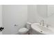 Small bathroom with white sink, toilet, and oval mirror at 1698 Cultivation Ln # 541, Mount Pleasant, SC 29466