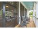 Screened porch with rocking chairs and view at 1698 Cultivation Ln # 541, Mount Pleasant, SC 29466