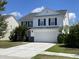 Two-story house with white siding, black shutters, and a white garage door at 144 Decatur Dr, Summerville, SC 29486