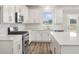 Modern kitchen with white cabinets, quartz countertops, and stainless steel appliances at 115 Ashley Cove Way, Summerville, SC 29483