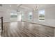 Large living room with hardwood floors, lots of windows, and a view of the backyard at 115 Ashley Cove Way, Summerville, SC 29483