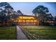 Stunning waterfront home at dusk, featuring a lighted deck and private boardwalk access at 3067 Marshgate Dr, Seabrook Island, SC 29455