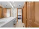 Double vanity bathroom with white cabinets and a view to bedroom at 3067 Marshgate Dr, Seabrook Island, SC 29455