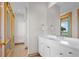 Bathroom with white vanity, a large mirror, and wood flooring at 3067 Marshgate Dr, Seabrook Island, SC 29455