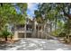 Two-story home with driveway, garage and lush landscaping at 3067 Marshgate Dr, Seabrook Island, SC 29455