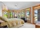 Primary bedroom with large windows, water views, and a sitting area at 3067 Marshgate Dr, Seabrook Island, SC 29455