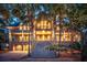 Two-story home with lighted staircase, attached garage, and palm trees at 3067 Marshgate Dr, Seabrook Island, SC 29455