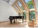 Elegant music room featuring a grand piano and large windows at 3067 Marshgate Dr, Seabrook Island, SC 29455