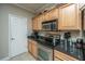 Well-equipped kitchen with light wood cabinets and granite countertops at 1984 Folly Rd # B304, Charleston, SC 29412