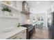 Modern kitchen with white cabinets, marble countertops and stainless steel range hood at 420 Carolina Cherry Ct # 101, Charleston, SC 29414