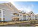 Two-story building with gray siding, wooden fence, and landscaping at 420 Carolina Cherry Ct # 101, Charleston, SC 29414