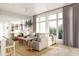 Spacious living room with large windows, hardwood floors, and comfortable seating at 618 Waterman St # 618, Charleston, SC 29492