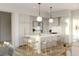 Modern kitchen with light cabinets, a large island, and a breakfast bar at 618 Waterman St # 618, Charleston, SC 29492