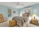 Charming bedroom with a queen-size bed and a rocking chair at 202 Needlerush Rd, Kiawah Island, SC 29455