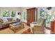 Living room with hardwood floors, large windows, and comfortable seating at 202 Needlerush Rd, Kiawah Island, SC 29455