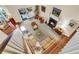 Open living area with hardwood floors, sectional sofa, and a fireplace at 202 Needlerush Rd, Kiawah Island, SC 29455