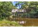 House exterior showcasing a waterfront view of a pond at 202 Needlerush Rd, Kiawah Island, SC 29455
