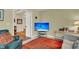 Relaxing den with leather chairs, a large TV, and hardwood floors at 202 Needlerush Rd, Kiawah Island, SC 29455