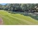 Expansive green golf course with shadows and a sand trap at 202 Needlerush Rd, Kiawah Island, SC 29455