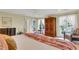 Bright bedroom with king-size bed and French doors leading to balcony at 202 Needlerush Rd, Kiawah Island, SC 29455