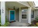 Front door entryway with teal door and porch at 166 Blackstone Dr, Moncks Corner, SC 29461