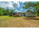 Home's backyard showcasing a deck, screened porch, and detached garage at 3820 Gardenhill Rd, Mount Pleasant, SC 29429