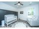 Charming Bedroom with crib, armchair, and dark accent wall at 3820 Gardenhill Rd, Mount Pleasant, SC 29429