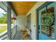 Inviting front porch with blue door, wood ceiling and comfy seating at 3820 Gardenhill Rd, Mount Pleasant, SC 29429