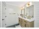 Elegant bathroom with double vanity, gold fixtures, and shiplap walls at 3820 Gardenhill Rd, Mount Pleasant, SC 29429