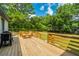 Wooden deck with built-in seating and grill, overlooking backyard at 3820 Gardenhill Rd, Mount Pleasant, SC 29429
