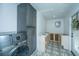 Laundry room with dark gray cabinets, washer, dryer, and patterned tile floor at 3820 Gardenhill Rd, Mount Pleasant, SC 29429