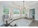 Relaxing sunroom with large windows, comfortable seating, and a baby swing at 3820 Gardenhill Rd, Mount Pleasant, SC 29429