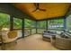 Relaxing screened porch with wicker furniture and ceiling fan at 3820 Gardenhill Rd, Mount Pleasant, SC 29429