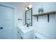 Modern bathroom with white vanity, black matte fixtures, and floating shelf at 3820 Gardenhill Rd, Mount Pleasant, SC 29429