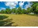 Spacious backyard with mature trees and large grassy area at 3820 Gardenhill Rd, Mount Pleasant, SC 29429