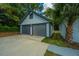 New detached two-car garage with gray doors and white exterior at 3820 Gardenhill Rd, Mount Pleasant, SC 29429