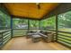 Spacious screened porch with comfortable seating and ceiling fan at 3820 Gardenhill Rd, Mount Pleasant, SC 29429