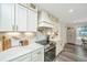 Elegant kitchen with white cabinets, marble countertops, and stainless steel appliances at 3820 Gardenhill Rd, Mount Pleasant, SC 29429