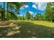 Large backyard with mature trees and grassy area at 3820 Gardenhill Rd, Mount Pleasant, SC 29429