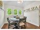 Charming round dining table with four chairs sits under three windows at 1720 Live Oak Park, Seabrook Island, SC 29455
