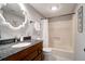Bathroom with granite countertop, dark wood cabinets, and bathtub at 1720 Live Oak Park, Seabrook Island, SC 29455