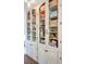 White distressed cabinets with wire mesh inserts offer stylish storage at 1720 Live Oak Park, Seabrook Island, SC 29455
