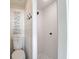 Small bathroom with toilet and walk-in shower, featuring white tile and shiplap at 1720 Live Oak Park, Seabrook Island, SC 29455