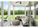 Relaxing screened porch with sectional seating overlooking a lush green lawn at 233 Claret Cup Way, Charleston, SC 29414