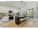 Modern kitchen with white cabinets, a large island, and stainless steel appliances at 233 Claret Cup Way, Charleston, SC 29414