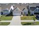 Gray house with white garage door and landscaping in a neighborhood at 253 River Martin Ct, Summerville, SC 29483