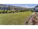 Spacious backyard with grassy lawn, shrubs, and a black metal fence at 253 River Martin Ct, Summerville, SC 29483