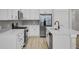 Modern kitchen with white cabinets, stainless steel appliances, and quartz countertops at 253 River Martin Ct, Summerville, SC 29483