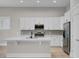 Modern kitchen with white cabinets, quartz countertops, and stainless steel appliances at 253 River Martin Ct, Summerville, SC 29483