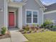 Inviting red front door entry with landscaping and walkway at 253 River Martin Ct, Summerville, SC 29483